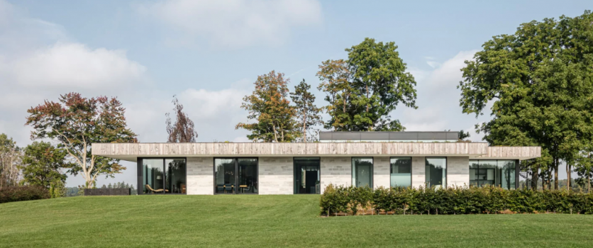 chris collaris architects designs villa with locally-sourced materials amidst meadow in canada