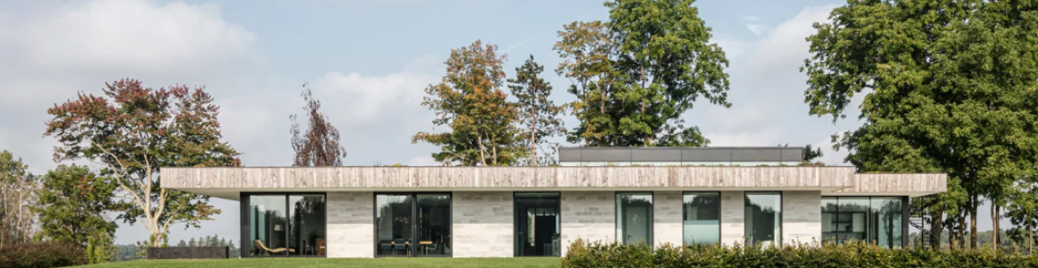 chris collaris architects designs villa with locally-sourced materials amidst meadow in canada